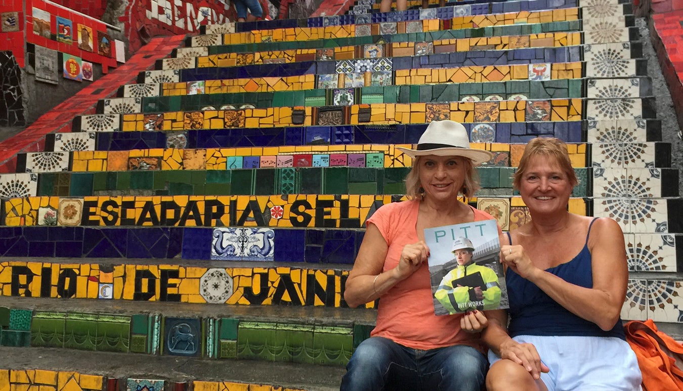Christine Palamidessi (A&S ’73) and Patricia Borneman DiNardo (NURS ’78) pause for a moment on the Selaron Steps in Rio de Janeiro, Brazil, to show their favorite traveling companion, Pitt Magazine. 