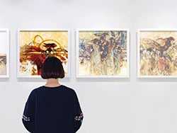 A woman looks at abstract art on the wall