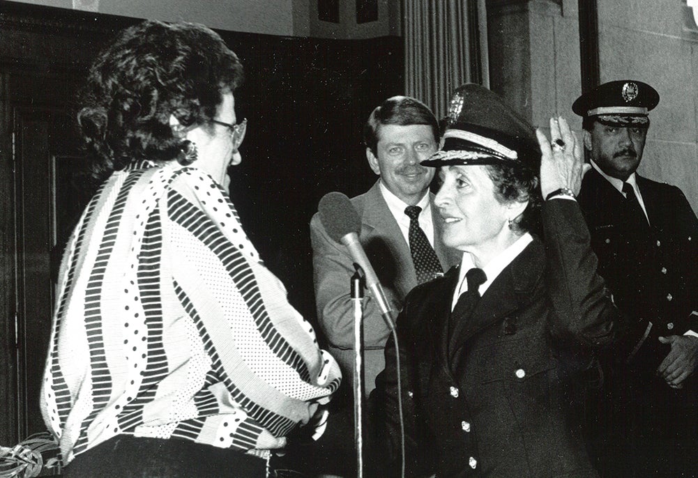 Rocco is sworn in in her police dress uniform, her left hand raised